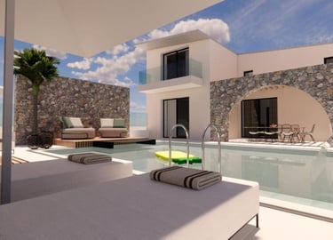 Luxury modern villa with private pool, stone walls, and sun loungers under a bright blue sky.