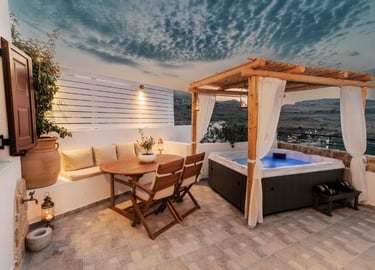 Luxury rooftop terrace with a private hot tub, wooden dining set, and scenic sunset views.