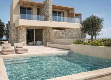 Luxury villa with a private infinity pool, stone walls, and sun loungers on a modern patio.