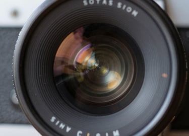 A vibrant behind-the-scenes shot of a film crew capturing an energetic outdoor challenge event.