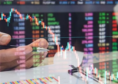 Stock market trader analyzing financial data and candlestick charts for investment trends.