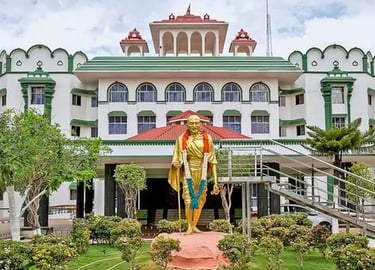 Madras high court building in Tamil Nadu with Gandhi statue at entrance