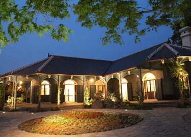 Illuminated Former Glover House at night in Nagasaki, a historic Western-style residence with scenic