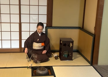 Woman preparing matcha tea during a traditional Japanese tea ceremony experience