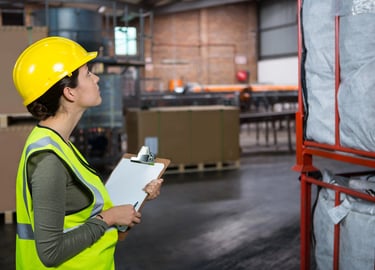 a woman in a yellow safety vest and a clipboard