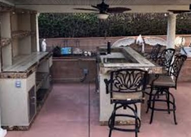 a kitchen with a bar stool and a bar stool