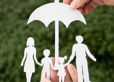 a person holding a paper cutout of a family