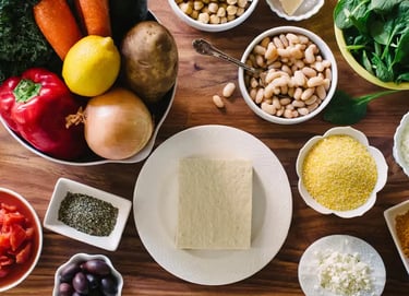 a table with bowls of food and vegetables