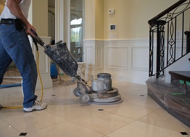a man is cleaning a tile floor in a house