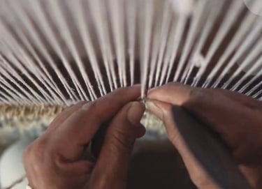 Artisan handknotting a rug in Bhadohi, India