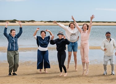 a group of people standing on a beach