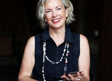 a woman in a black dress and pearls necklaces