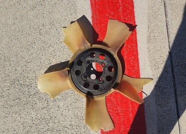 Broken cooling fan on ground