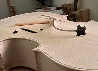 cello in the white with a soundpost and a sound post setter