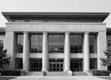 A black and white photograph of a modern library facade in the USA, emphasizing symmetry and professional academic structure, with high contrast lighting.