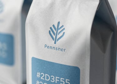 Close-up of premium sustainable packaging design with embossed logos and tactile textures. The lighting is dramatic, highlighting the structural integrity and quality of the materials. Incorporates #8D9FB5 and #2C3E50 tones. Modern and sophisticated.