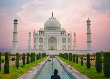 a man standing in front of a building with a fountain