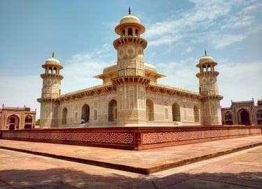 a large white building with two towers and a clock tower