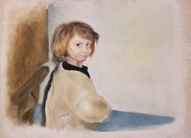 Young girl with mousy coloured bobbed hair. Dark blue top with Cardigan on top looks at viewer.