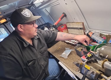a man in a black shirt and a hat on a table