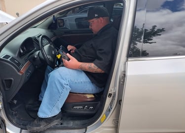 a man in a black shirt is sitting in a car