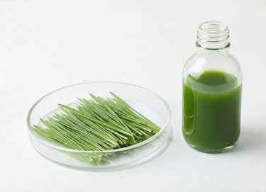 Fresh green wheatgrass blades in a petri dish next to a glass bottle of organic wheatgrass juice.