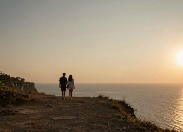 A cinematic shot of a couple walking along a quiet Uluwatu cliff at sunset. Golden hour lighting casting long shadows, minimalist horizon, featuring earthy tones of #7B6654 and #C8B6A6.