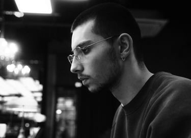a man in glasses and a black shirt