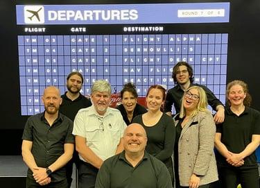 people standing in from of an airport board