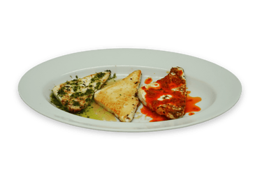 Three grilled halloumi cheese slices served on a white plate with pesto, plain, and chili oil toppings.