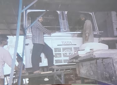 Old workshop photo showing a skilled worker fabricating a truck body at MS Engineering Works, Sonipa