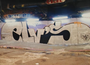 Graffiti writing on urban wall — European street art lettering Kende background