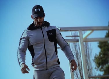 a man in a gray jacket and black pants