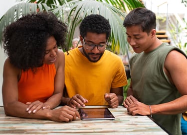 a group of people standing around a table make the interactive