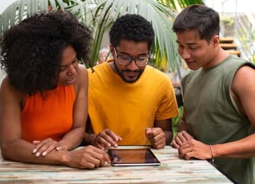 a group of people standing around a table