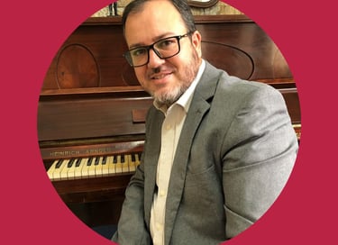 a man in a suit and tie smiling at the camera