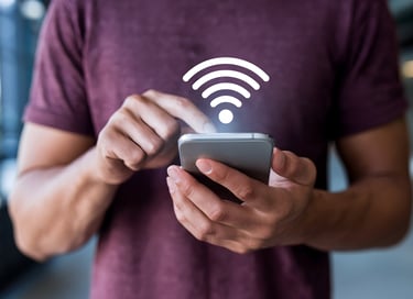 a man holding a cell phone looking for wifi connection