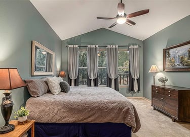 a bedroom with a ceiling fan and a ceiling fan