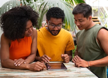 a group of people standing around a table