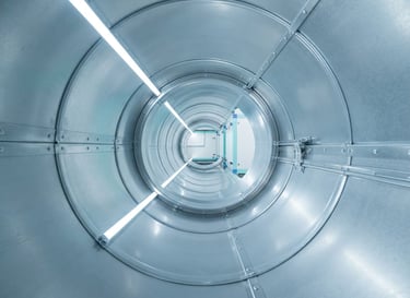 Pristine metal duct interior reflecting bright clean LED light, clinical sharp focus, 35mm