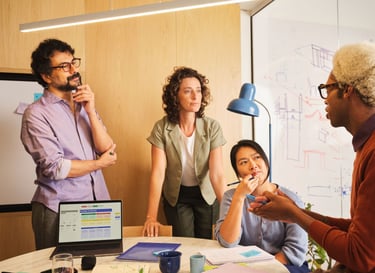 Diverse team of creative professionals collaborating on a marketing strategy in a modern office.