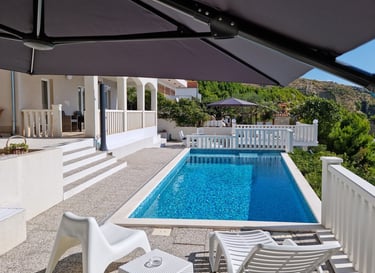 View from the west sun terrace of the pool, apartment balcony and the east sun terrace.