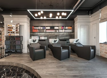 Modern  spa & salon interior with professional black leather chairs, and luxury hair products.