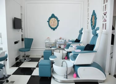 Modern luxury nail salon interior with blue pedicure chairs and foot baths on a black and white chec