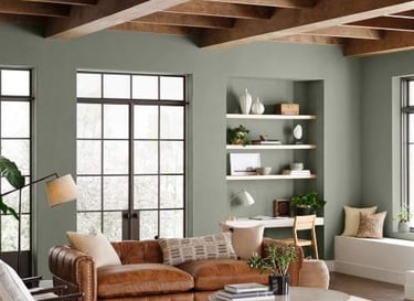 Living room with exposed ceiling beams, seating, and built-in shelving.