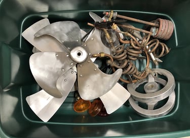 Metal parts in a sculptor's workshop bin, image 2.