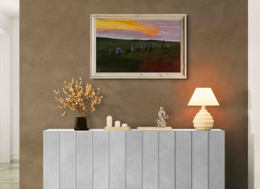 Modern white fluted sideboard featuring a landscape painting and table lamp against a brown wall.