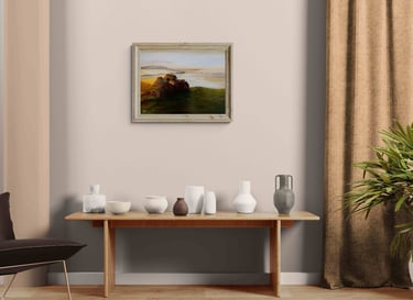 Framed landscape oil painting hanging above a wooden console table with ceramic vases in a modern minimalist room.