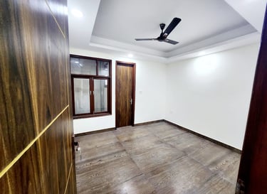 Spacious Bedroom of 3 BHK Builder Floor Near Sky Mansion Chattarpur with false ceiling and window