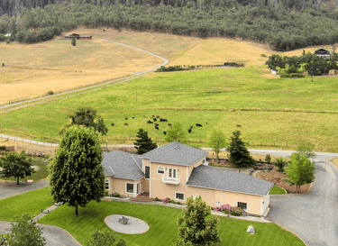 a large house with a large yard and a large field